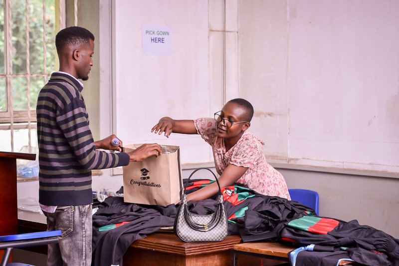 Graduands doing fitting for their gowns before graduation day 3