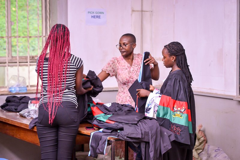 Graduands doing fitting for their gowns before graduation day 2