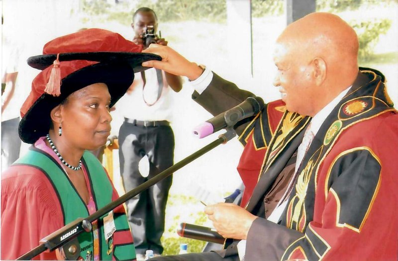 The Chancellor Prof. Mondo Kagonyera confers a PhD upon Prof. Helen Byamugisha (Left) on 17th January 2012